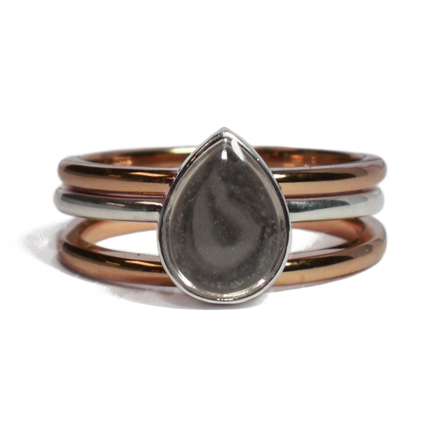 This photo shows the Pear Stacking Ashes Ring Set in Mixed Metals designed by close by me jewelry from the front