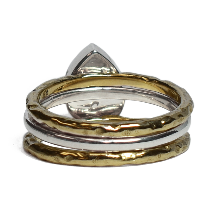 This photo shows the Pear Stacking Ashes Ring Set in Sterling Silver with two 14K Yellow Gold Companion Rings to create a stacking set by close by me jewelry from the back