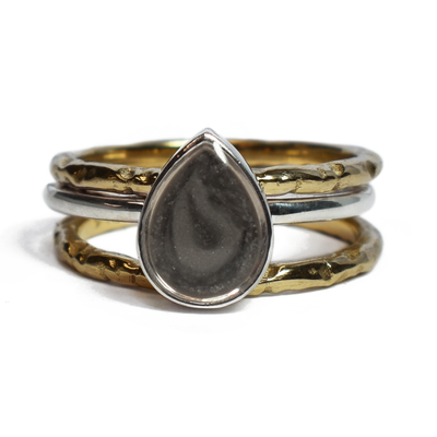 This photo shows the Pear Stacking Ashes Ring Set in Sterling Silver with two 14K Yellow Gold Companion Rings to create a stacking set by close by me jewelry from the front