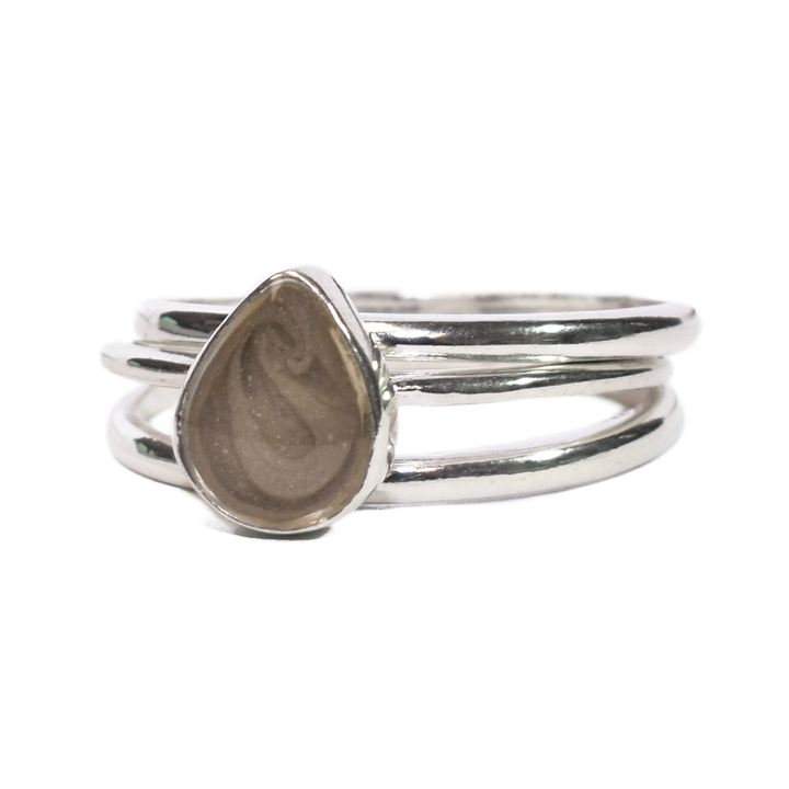 This photo shows the Sterling Silver Pear Cremated Remains Stacking Ring Set designed by close by me jewelry from the front at an angle to the left