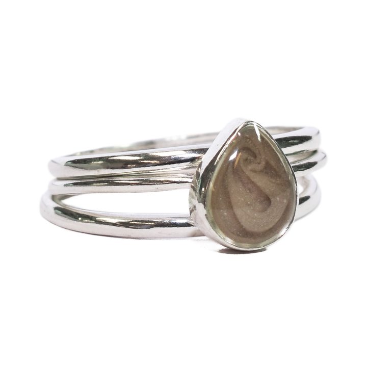 This photo shows the Sterling Silver Pear Cremated Remains Stacking Ring Set designed by close by me jewelry from the front at an angle to the right