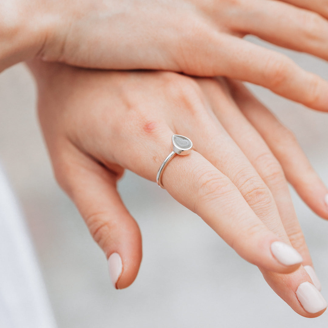 Pictured here is close by me jewelry's Sterling Silver Pear Stacking Ring on a model's finger