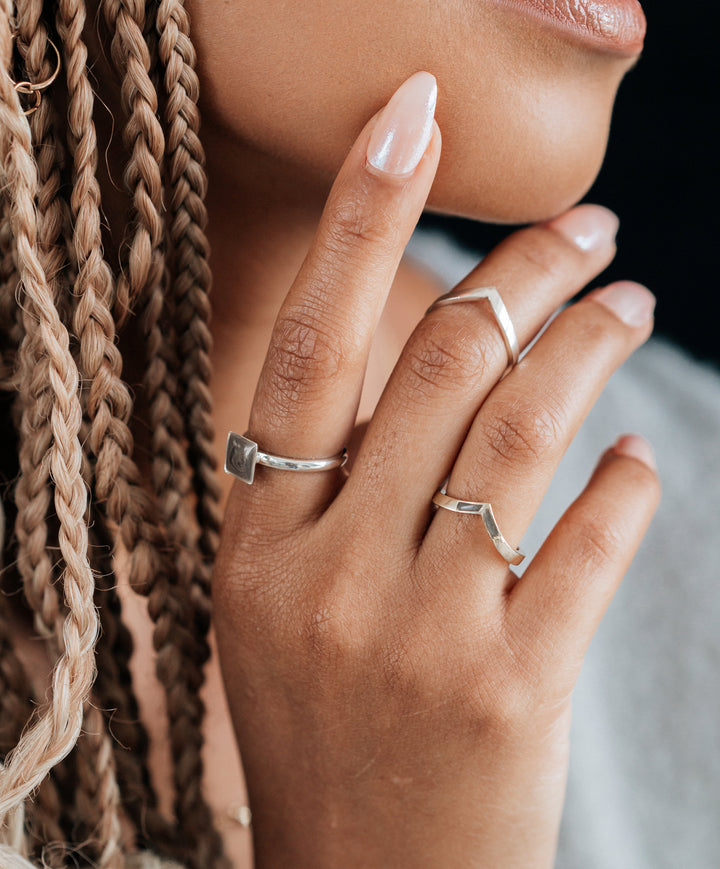 This photo shows the Sterling Silver Signature Square Stackable Band Cremains Ring with ashes set by close by me jewelry on a model's index finger