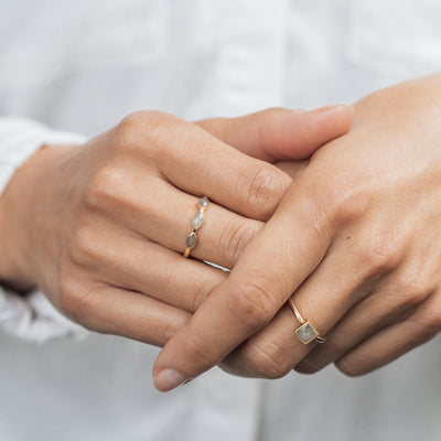 This photo shows the 14K Yellow Gold Three Setting Ashes Ring design by close by me jewelry being worn on a model's middle finger