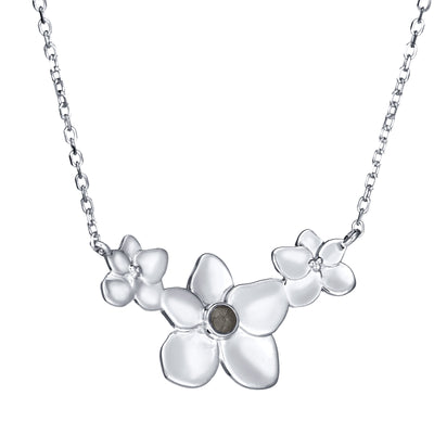 This photo shows the Hydrangea Cluster Cremation Necklace with cremated remains designed in 14K White Gold by close by me jewelry at an angle