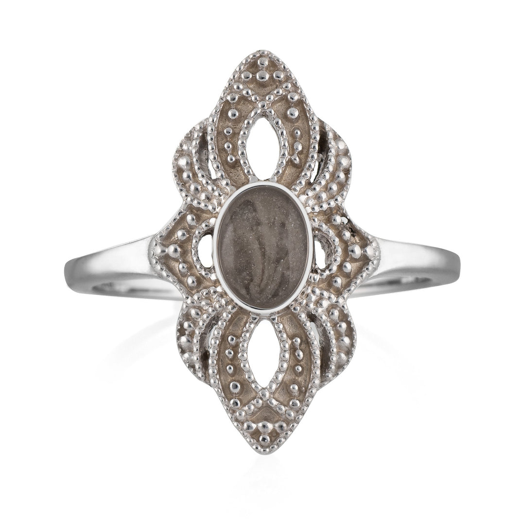Pictured here is a close-up front view of Close By Me Jewelry's vintage-style World War II Cremation Ring in 14K White Gold set against a solid white background. This version of the ring features a smaller oval bezel containing solidified cremated remains. The ashes setting in this picture is dark gray in color and has a subtle swirl design.
