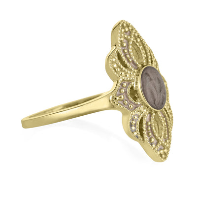 Pictured here is a close-up side view of Close By Me Jewelry's vintage-style World War II Cremation Ring in 14K Yellow Gold set against a solid white background. This version of the ring features a smaller oval bezel containing solidified cremated remains. The ashes setting in this picture is dark gray in color and has a subtle swirl design.